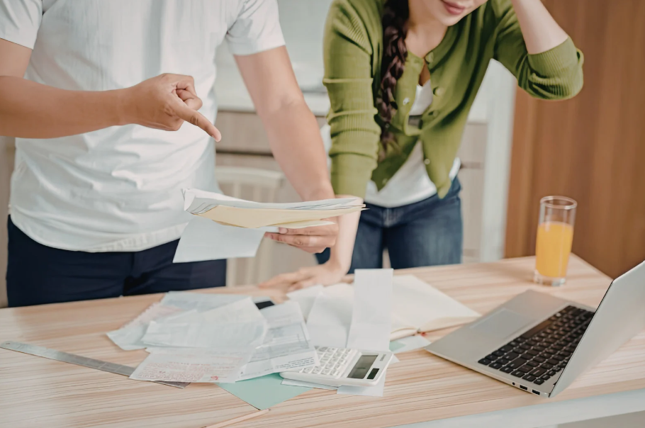 Couple reviewing bills to compare cable vs streaming cost at home.