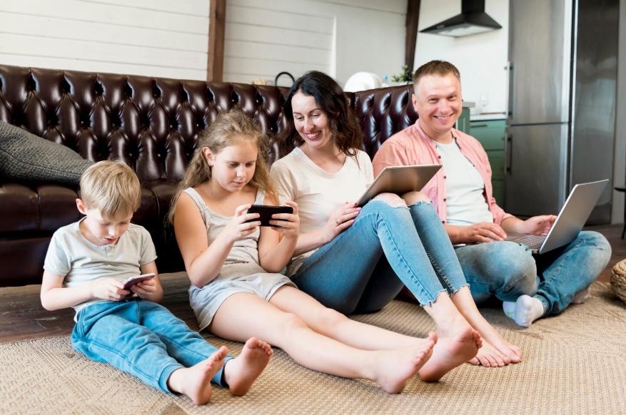 Family using multiple devices illustrating the benefits of streaming family plans at home.